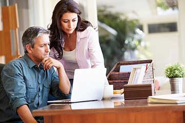 A couple looking at a laptop
