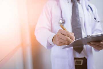 Close up of a doctor holding a clipboard