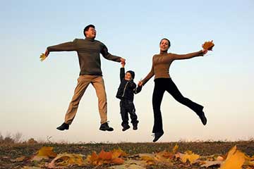 Parents and a child jumping in the air