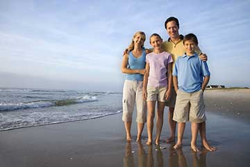A family posing for a photo on a beach