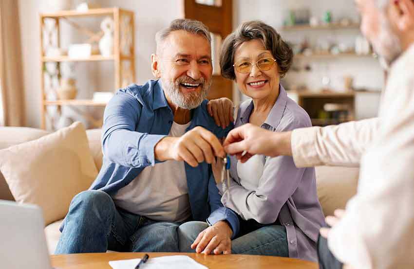 a couple getting the keys for their home